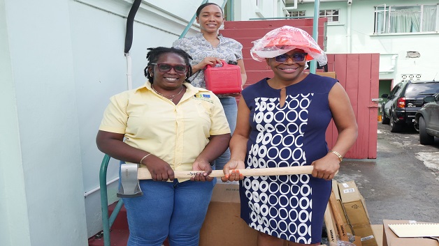(L-R) VEEP Project Officers Davina Roberts & Niska Stewart handing over cleanup equipment to Ministry Of Argiculture Permanent Secretary Nerissa Gittens (1)